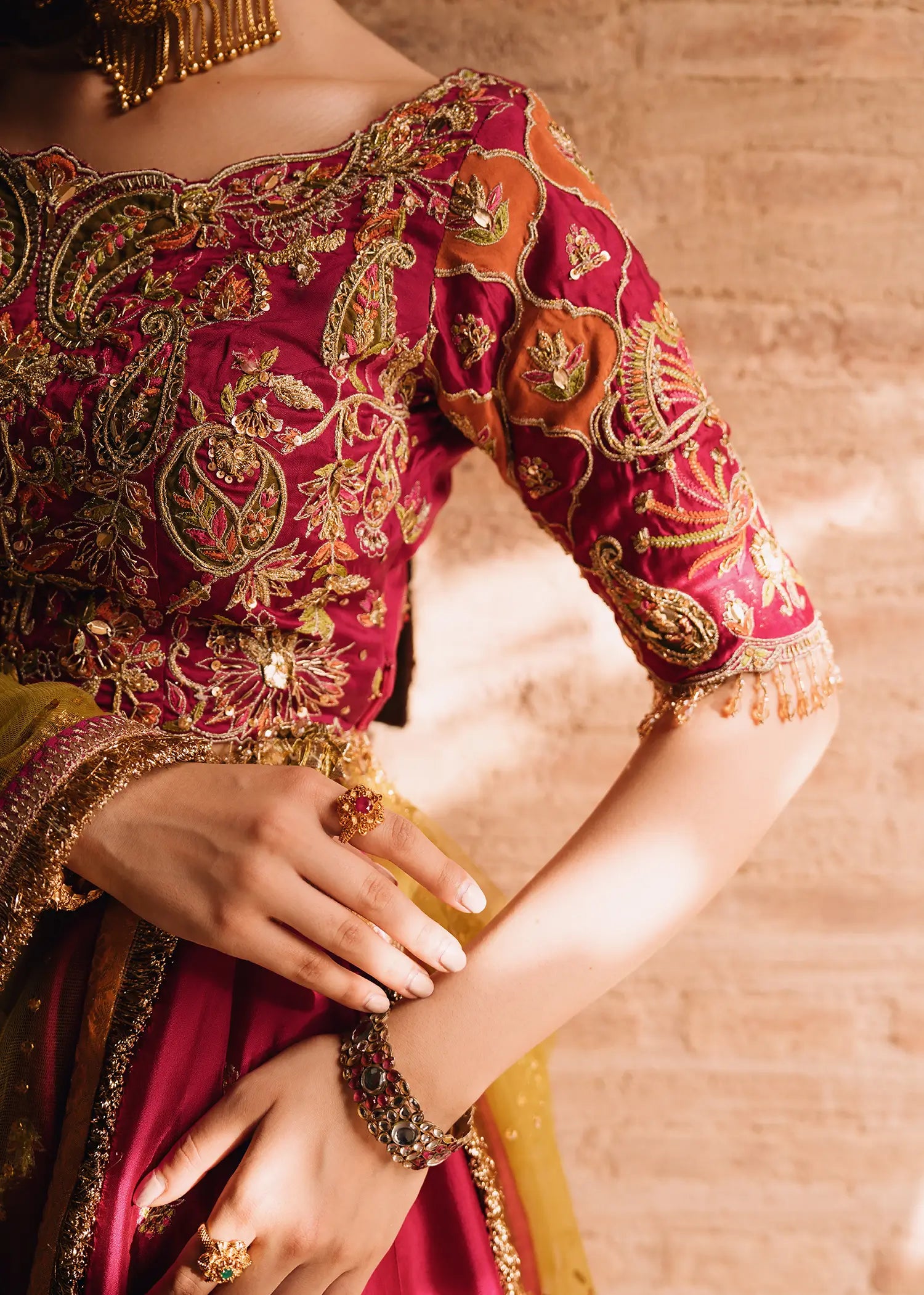 Fuschia Anaya magenta lehnga choli with traditional resham and gota embroidery paired with a contrasting olive-green dupatta for festive elegance.
