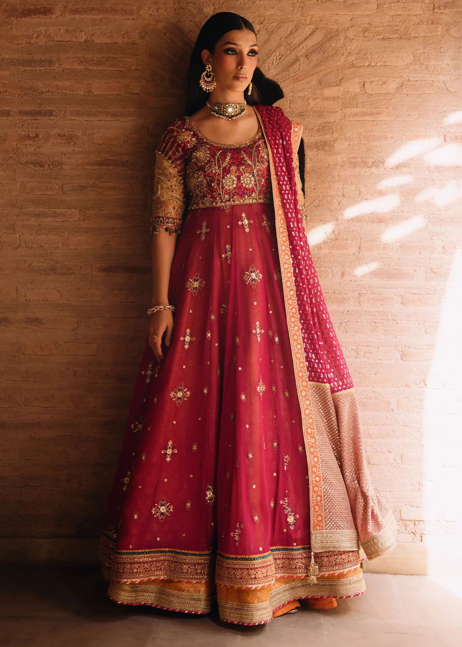 Fuschia Naaz radiant tussel silk silhouette in deep pink with mukesh net dupatta and detailed zardozi hand-embellishments.
