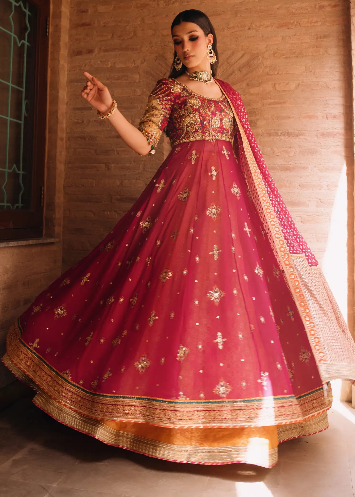 Fuschia Naaz radiant tussel silk silhouette in deep pink with mukesh net dupatta and detailed zardozi hand-embellishments.
