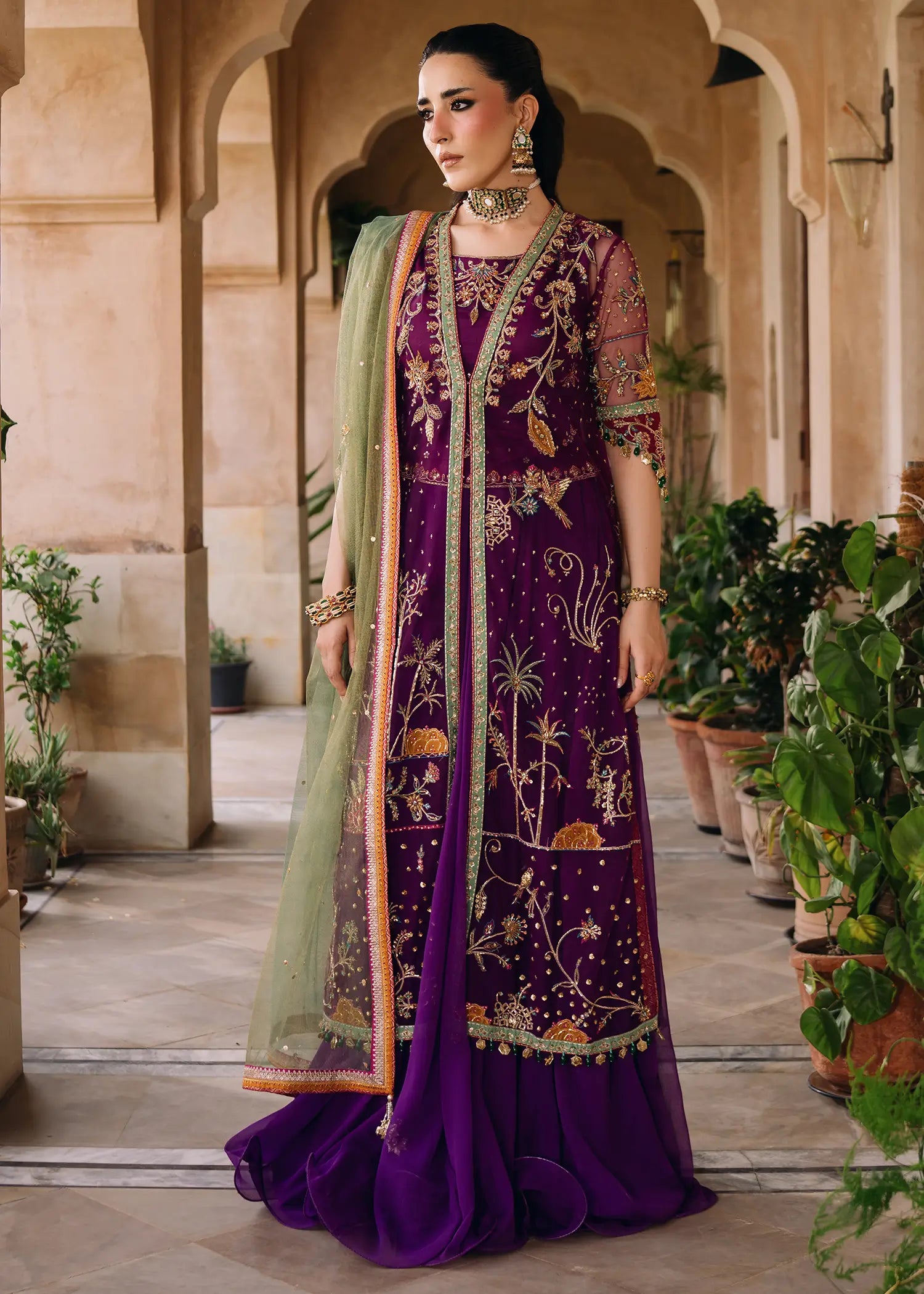 Magenta Zareen luxury net jacket with resham and zardozi embroidery paired with a flowing chiffon lehnga and khaddi net dupatta.
