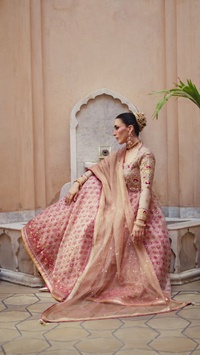 Orchid Pink ivory khaddi net kalidar with artisanal block-printed panels and a rich jamawar lehnga for a traditional Pakistani formal look.
