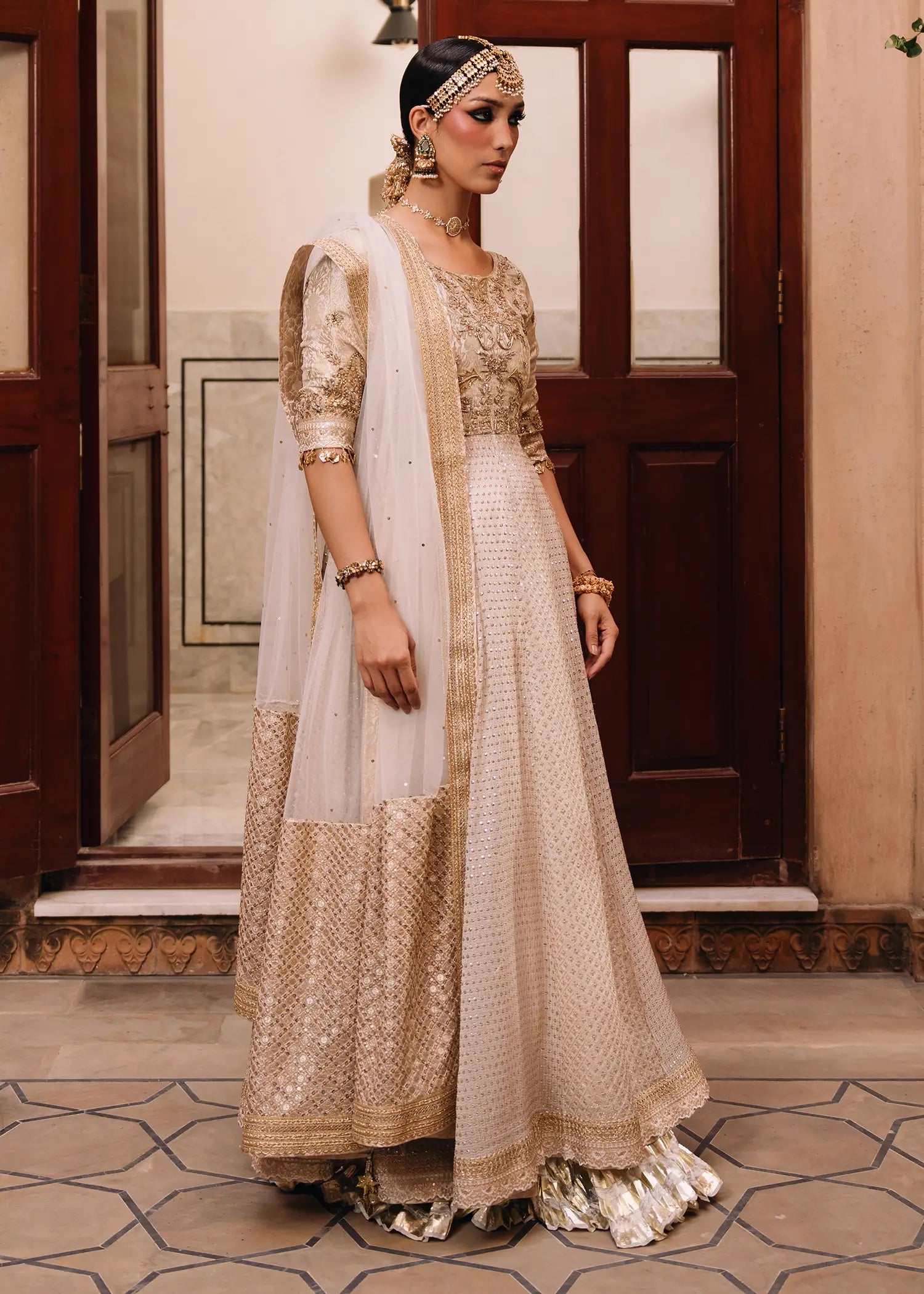 Sitara Kalidar ivory luxury formal dress with delicate cutwork, zardozi embroidery, and traditional block print panels for a timeless appeal.
