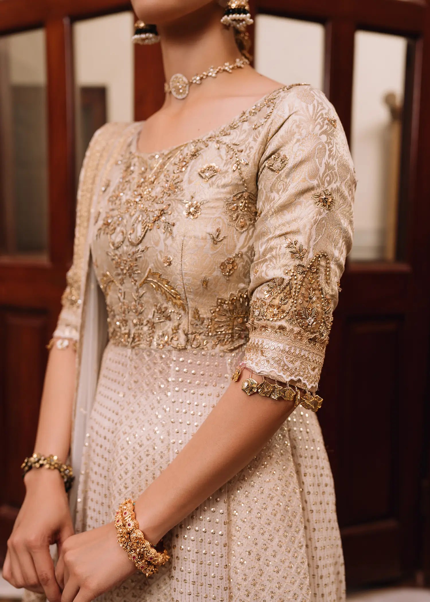 Sitara Kalidar ivory luxury formal dress with delicate cutwork, zardozi embroidery, and traditional block print panels for a timeless appeal.
